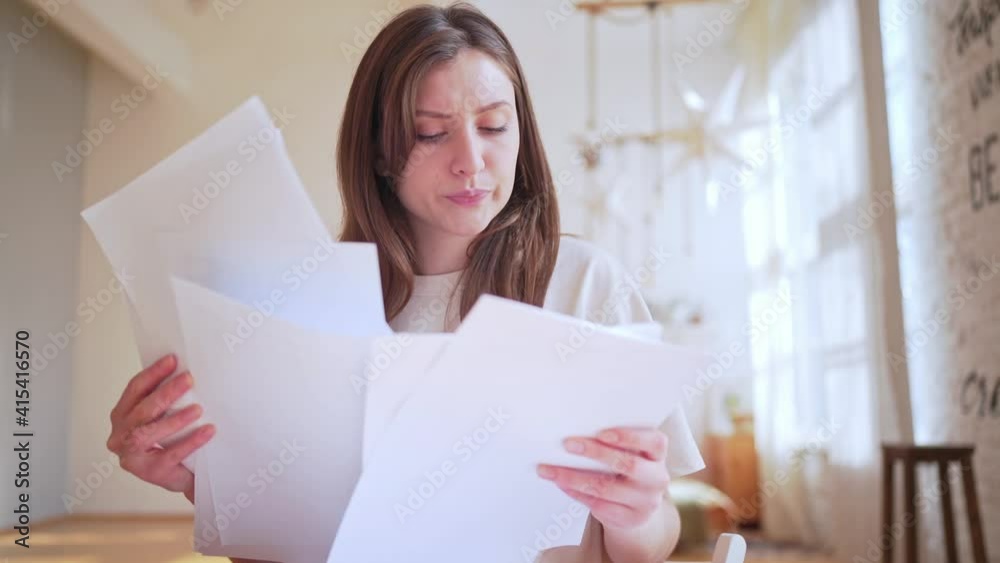 Overload with paperwork. Employed worker on the remote work at home Overload with paperwork. Employed worker on the remote work at home