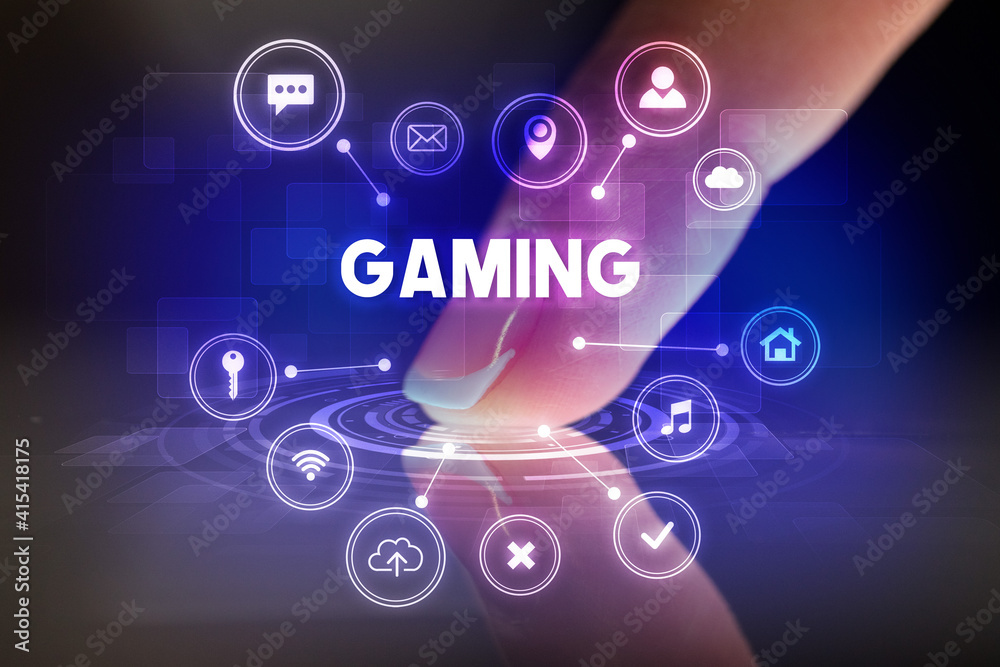 Finger touching tablet with web technology icons and GAMING inscription, web technology concept Finger touching tablet with web technology icons and GAMING inscription, web technology concept