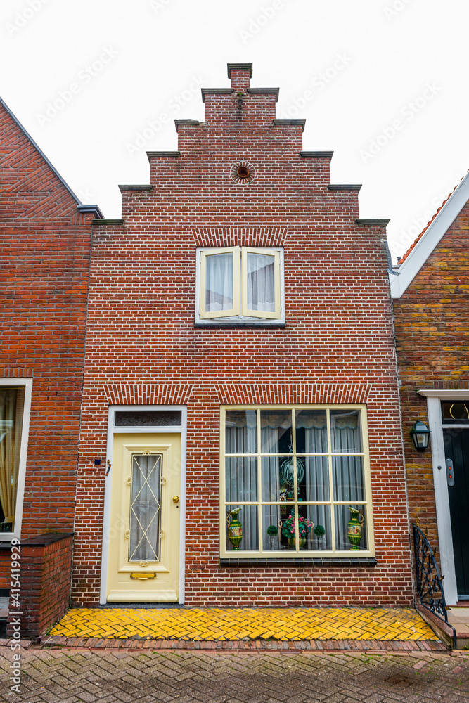 VOLENDAM, NETHERLANDS. Typical Dutch village houses in Volendam. Beautiful village houses facade.. VOLENDAM, NETHERLANDS. Typical Dutch village houses in Volendam. Beautiful village houses facade..