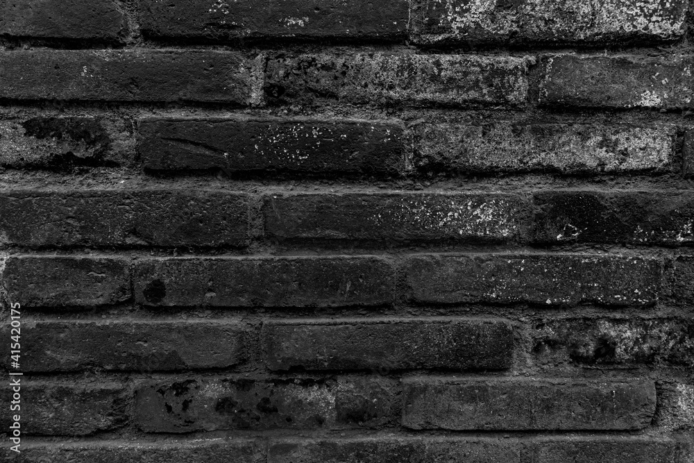 Texture of old dark scary dirty crumbling brick wall of ancient city. Uneven pitted surface of the brickwork of the damp basement with holes and worn. Decayed burnt brickwall background for 3D design Texture of old dark scary dirty crumbling brick wall of ancient city. Uneven pitted surface of the brickwork of the damp basement with holes and worn. Decayed burnt brickwall background for 3D design