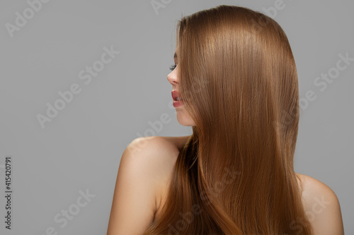 Woman's clean styled hair. Half of the face is covered with brunette hair