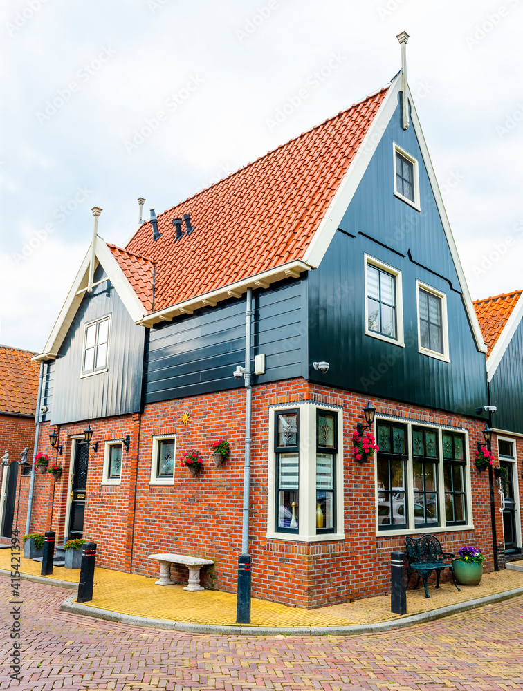 VOLENDAM, NETHERLANDS. Typical Dutch village houses in Volendam. Beautiful village houses facade. VOLENDAM, NETHERLANDS. Typical Dutch village houses in Volendam. Beautiful village houses facade.