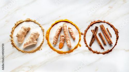 Foto Circle of ingredients spices for masala tea on marble background