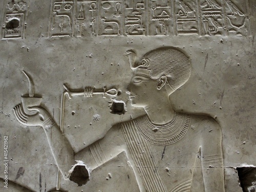 close up carving of young king pharaoh in Seti temple in Sohag in Egypt photo