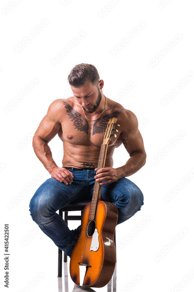 Portrait of muscular man with tattoo playing guitar. Isolated on white background. Full length shot Portrait of muscular man with tattoo playing guitar. Isolated on white background. Full length shot