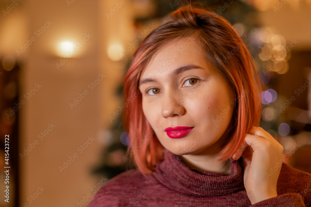 Beautiful woman on the background of a Christmas tree Beautiful woman on the background of a Christmas tree