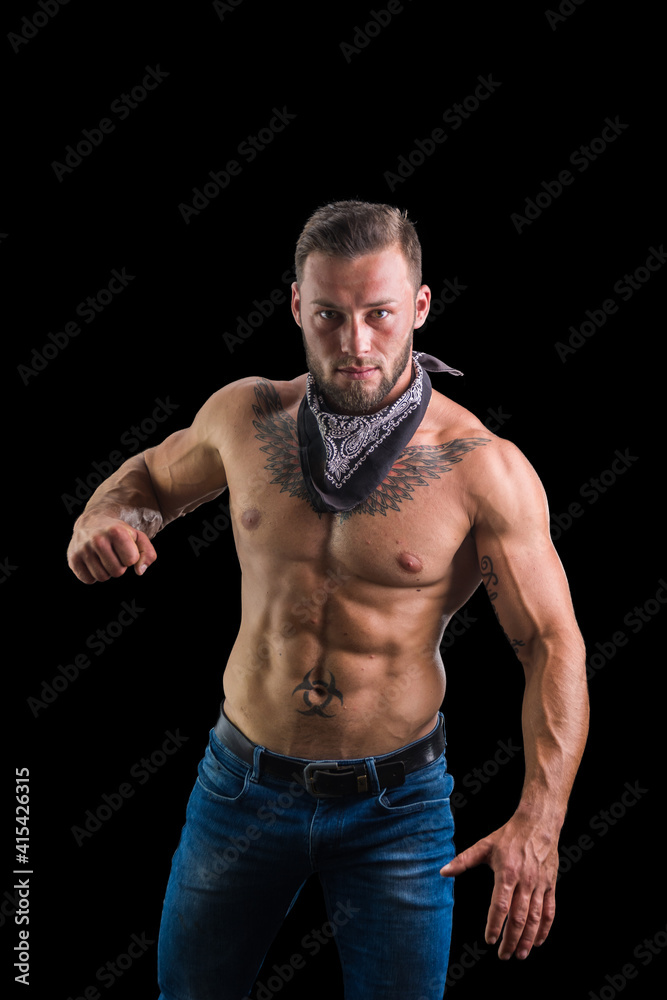 Shirtless male model ready to throw punch towards camera, on black background, with bandana around neck