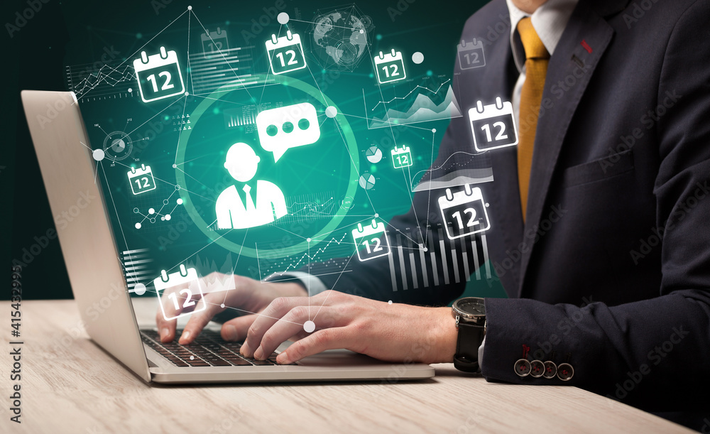 Business hand working on laptop with leader icons coming out from the screen, successful business concept Business hand working on laptop with leader icons coming out from the screen, successful business concept