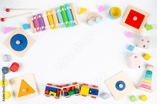 Sustainable zero waste colorful educational and musical toys for baby kids on white background. Top view, flat lay frame