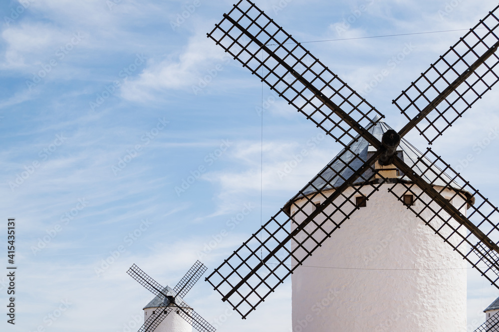 Old white windmills against blue sky in Campo de Criptana, Castile la Mancha, Spain. 