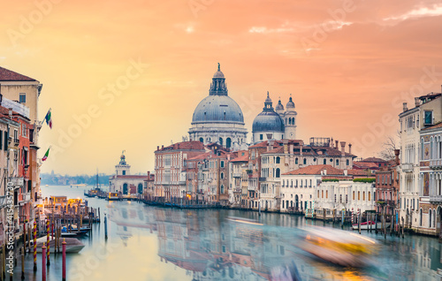 Stunning view of the Venice skyline with the Grand Canal and Basilica Santa Maria Della Salute in the distance during a dramatic sunrise. Picture taken from Ponte Dell’ Accademia.