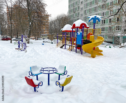 Children's playground covered with snow