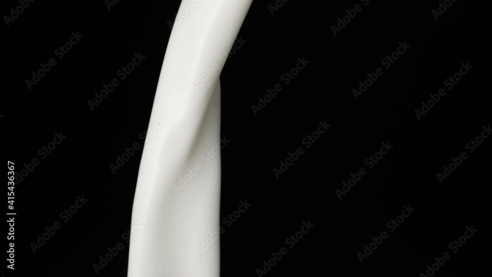Macro shot of milk stream falling in slow motion Macro shot of milk stream falling in slow motion