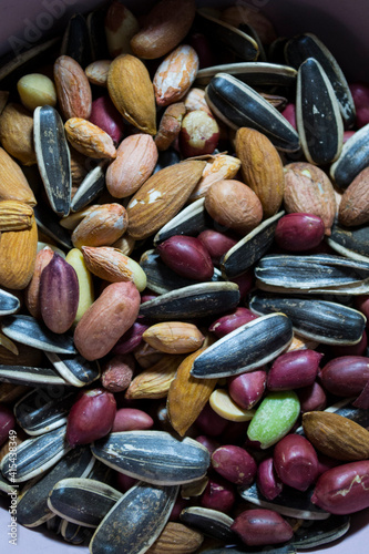 A mixture of different types of nuts and seeds. Ground nuts, almonds, seeds.