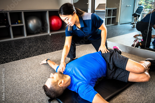 Physiotherapist working with client on rehabilitation exercises
