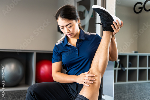 Physiotherapist working with client on rehabilitation exercises