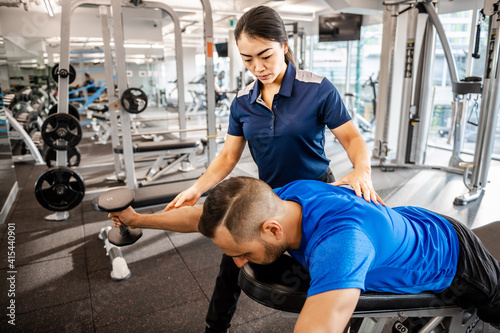 Physiotherapist working with client on rehabilitation exercises
