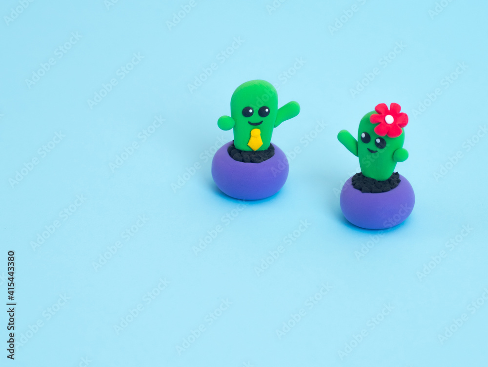 Fototapeta premium Funny plasticine toys on the blue background with copy space