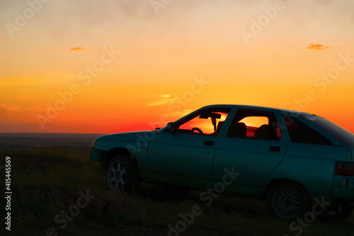 Meeting the sunset from a high slope in the cabin of the car. © Ксения Граденко