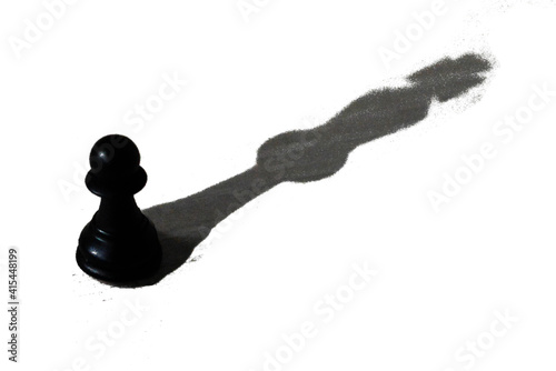 Black pawn with the shadow of a king as a symbol of self confidence	