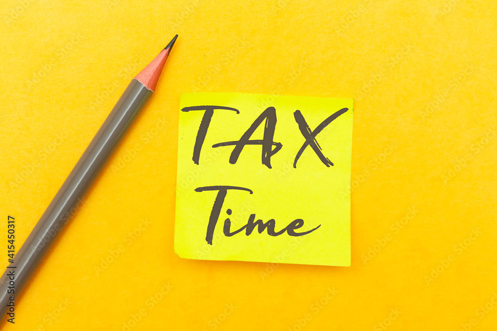 Tax time - Notification of the need to file tax returns with pencil on yellow background Tax time - Notification of the need to file tax returns with pencil on yellow background