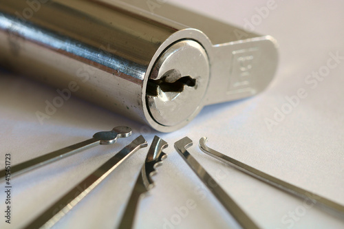 A Euro Lock surrounded by a selection of different lock picking tool.