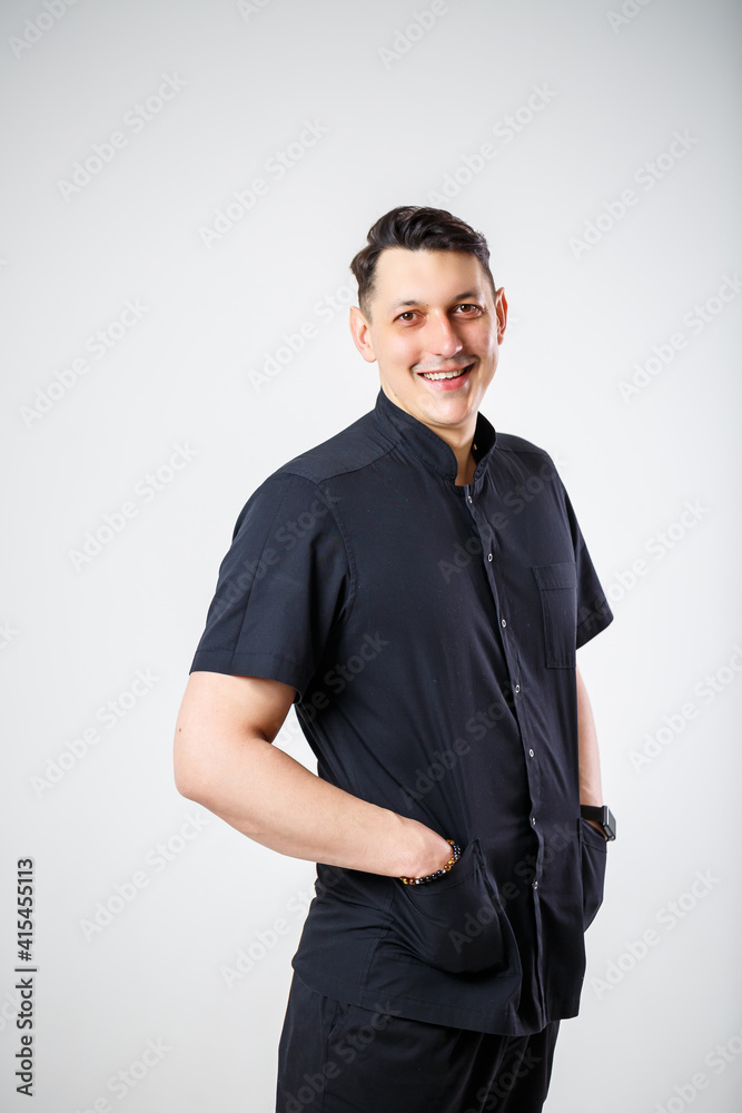 Fototapeta premium Close-up portrait of a young male doctor in medical clothes.
