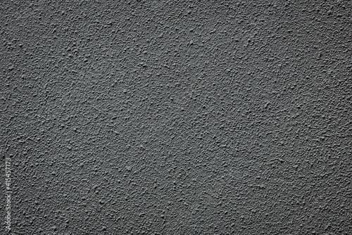 Gray cement wall which has a rough, bumpy surface that looks like sand It is a loft style decoration.