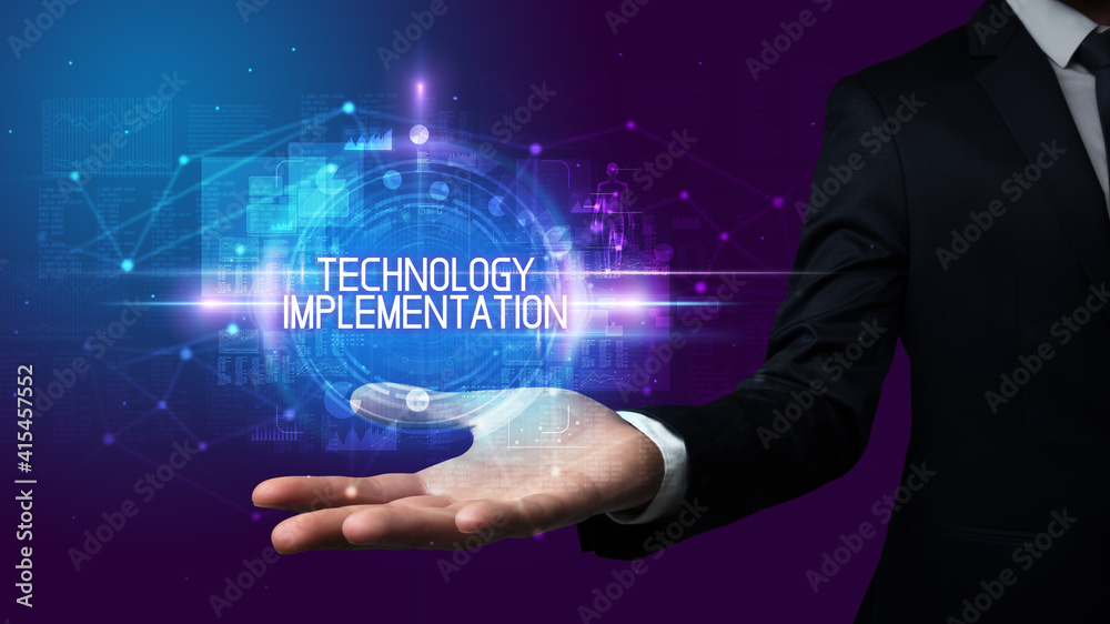 Man hand holding TECHNOLOGY IMPLEMENTATION inscription, technology concept
