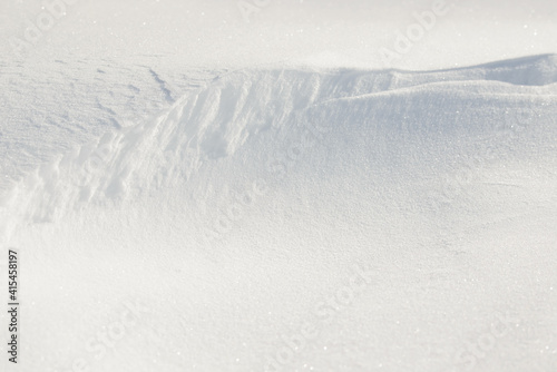 Fresh clean white snow background texture. Winter background with frozen snowflakes and snow mounds. Snow lumps. Seasonal landscape details. Cold weather.