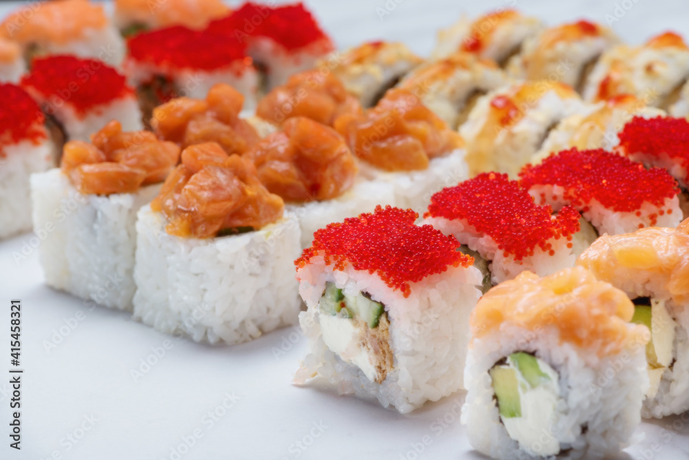 Sushi set with tuna, shrimp, salmon, and rice on the dark background Sushi set with tuna, shrimp, salmon, and rice on the dark background
