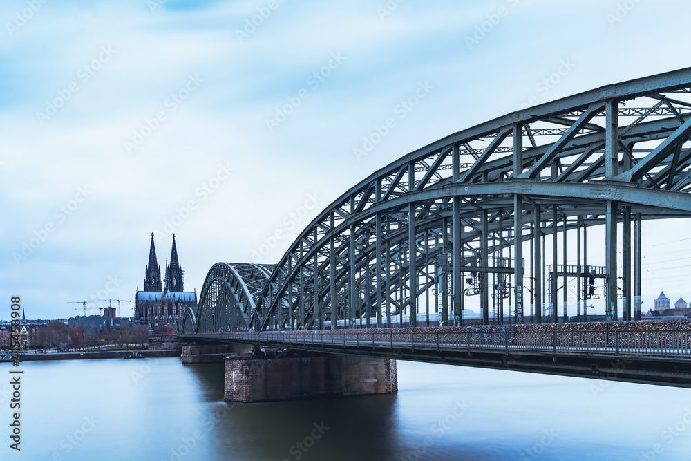 Hohenzollern Bridge over the Rhine River and Cologne Cathedral on sunset 
