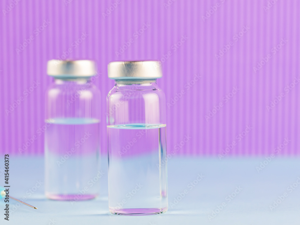 Vaccine and syringe injection. Vaccines and syringe on a purple background for prevention and immunization. Vaccine and medical concept. Copy space