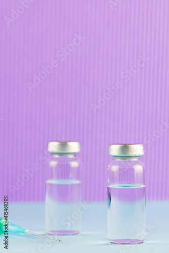 Vaccine and syringe injection. Vaccines and syringe on a purple background for prevention and immunization. Vaccine and medical concept. Copy space