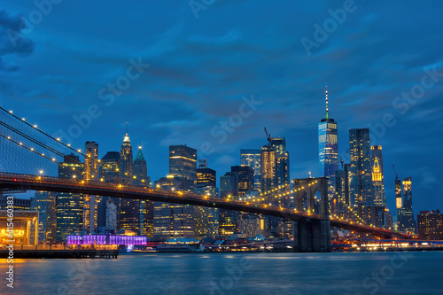 Brooklyn Bridge with panoramic views of  Manhattan at night, New York City, USA © Marcin