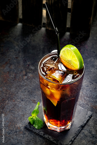 Картината върху платно Classic Cuba Libre cocktail with brown rum, cola and lime, long drink at the Cub
