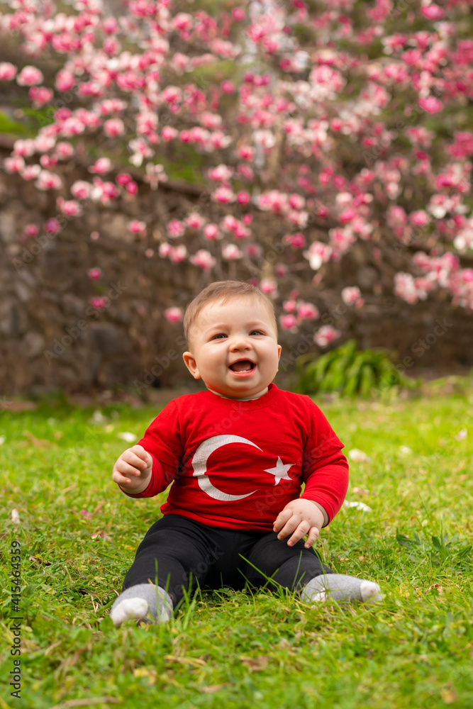 Portrait of happy little kid, cute baby toddler with Turkish flag t-shirt. Patriotic holiday. Adorable child celebrates national holidays. Blur background with copy space for text. Portrait of happy little kid, cute baby toddler with Turkish flag t-shirt. Patriotic holiday. Adorable child celebrates national holidays. Blur background with copy space for text.