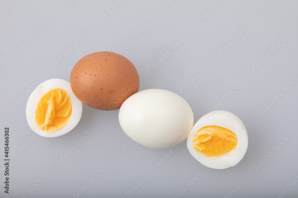 Hard boiled egg with shell and peeled boiled egg on white background Hard boiled egg with shell and peeled boiled egg on white background