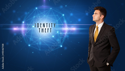 Businessman thinking about security solutions with IDENTITY THEFT inscription