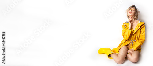 Photos Horizontal banner with young woman in illuminating yellow slicker and rubber boots