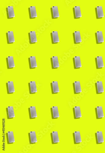 Vertical pattern with smartphones on a yellow green background. Background of gadgets.