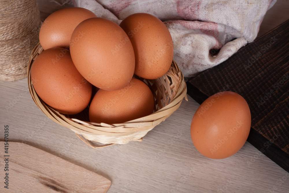 Fresh chicken eggs on a textured wooden table. Fresh chicken eggs on a textured wooden table.