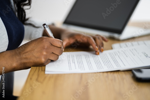 African Lawyer Signing Legal Business Document