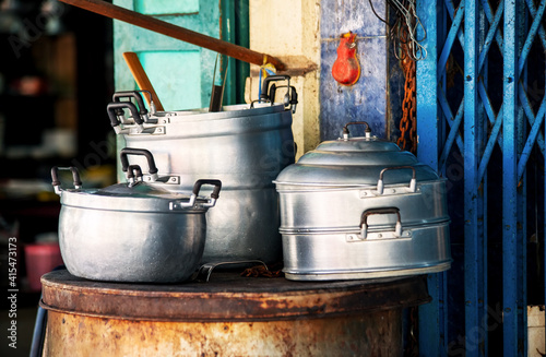 Metal dishes on the street in a poor area of Thailand