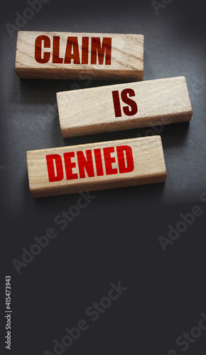 Claim is denied on Wooden Blocks on dark grey background with copyspace. The answer is No. Business financing sponsorship concept