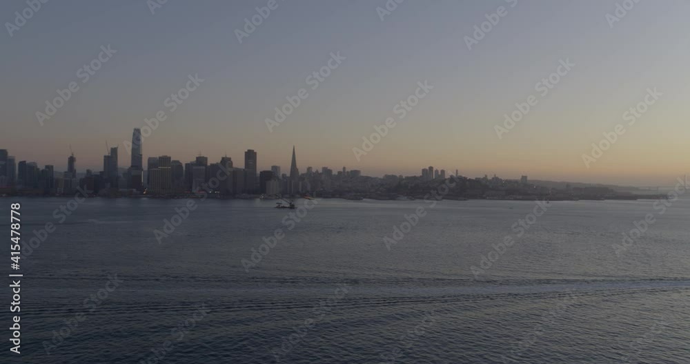 San Francisco Skyline at Dusk and Commuter Ferry on Bay San Francisco Skyline at Dusk and Commuter Ferry on Bay