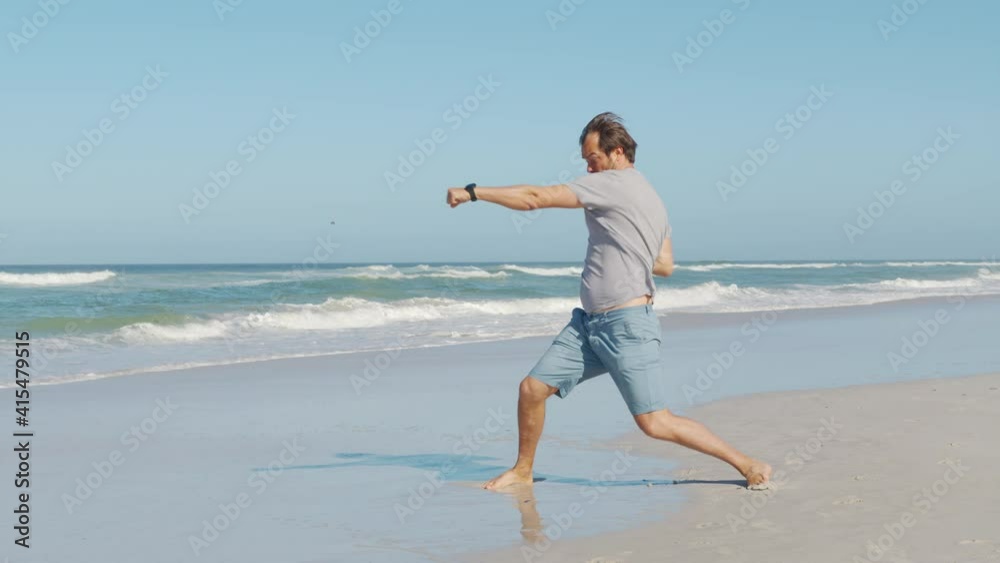 Cheerful and happy young man actively dancing while walking down the ocean. Cheerful and happy young man actively dancing while walking down the ocean.