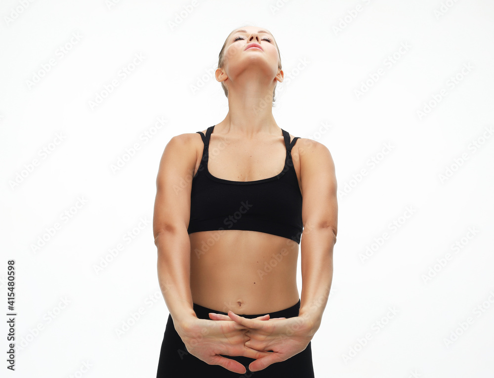 Portrait of healthy woman stretching her arms, exercising over white background. Portrait of healthy woman stretching her arms, exercising over white background.