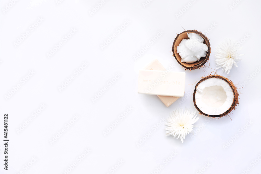 Top view Organic healthy coconut butter with soap and fresh coconut pieces over white background Top view Organic healthy coconut butter with soap and fresh coconut pieces over white background