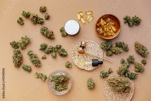 Medical marijuana buds with oil and glass pipe. Top view, flat lay